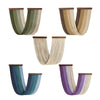 A collection of five vertical macrame wall tapestries in various shades of green, beige, and purple.