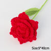 A handmade red crochet rose flower attached to a green stem, used for home decor or gifting.