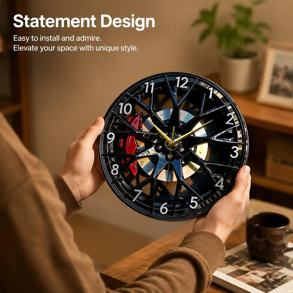 A hand holds a black acrylic wall clock with a creative 2D tire wheel design, showing the clock face and hands.