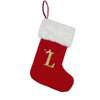 A red Christmas stocking with a white fluffy cuff featuring a gold letter L