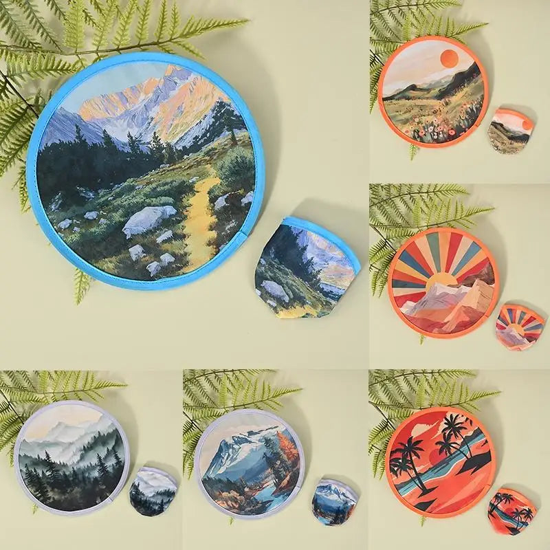 A collection of round handheld cooling fans in various colors and designs set against a light background.