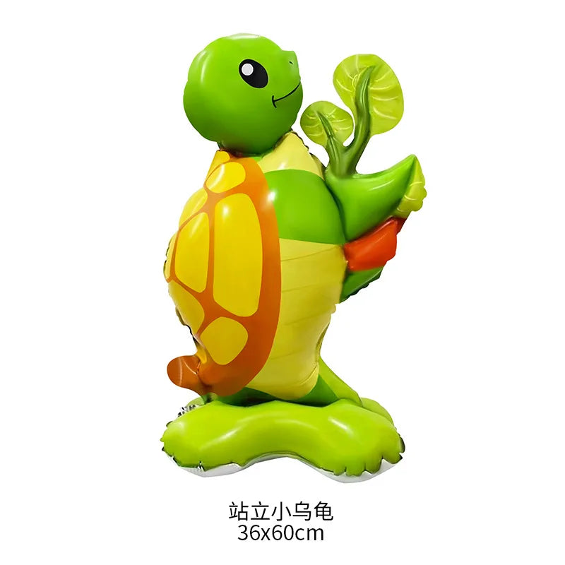 A green foil balloon shaped like a small frog with yellow and orange markings.