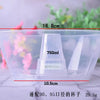 A clear plastic disposable cup with measurements marked on it, shown against a blurred background.