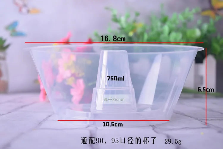 A clear plastic disposable cup with measurements marked on it, shown against a blurred background.