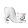 A white ceramic cartoon cat planter shaped like a sleeping cat with a long tail.