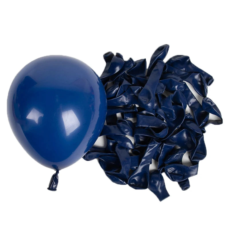 A blue latex balloon next to a pile of dark blue crumpled latex balloons.