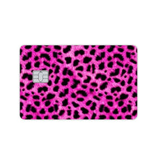 A close-up of a pink leopard print card skin designed for credit and debit cards.
