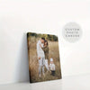 A custom framed canvas poster featuring a family of three outdoors in a grassy field.