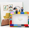A DIY building block photo frame kit featuring various colored blocks and a wooden frame with a figure.