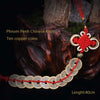 A necklace featuring a Chinese knot and ten copper coins, displayed against a dark background.
