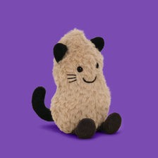 A fluffy brown and black Christmas peanut and reindeer plush toy with antlers and a scarf.