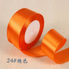 Roll of orange silk satin ribbon for gift wrapping and craft projects