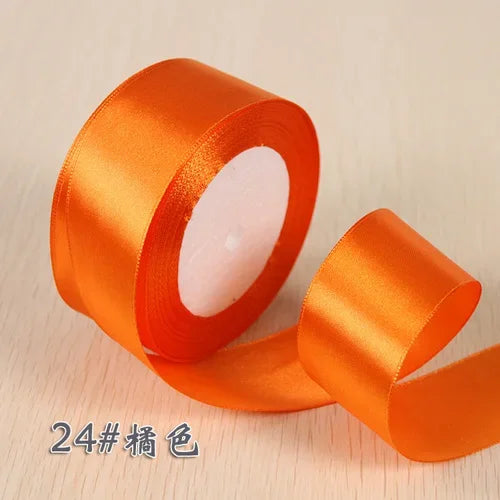 Roll of orange silk satin ribbon for gift wrapping and craft projects