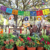 Decorative felt flags strung across a wooden frame with skeletal and colorful fabric designs.
