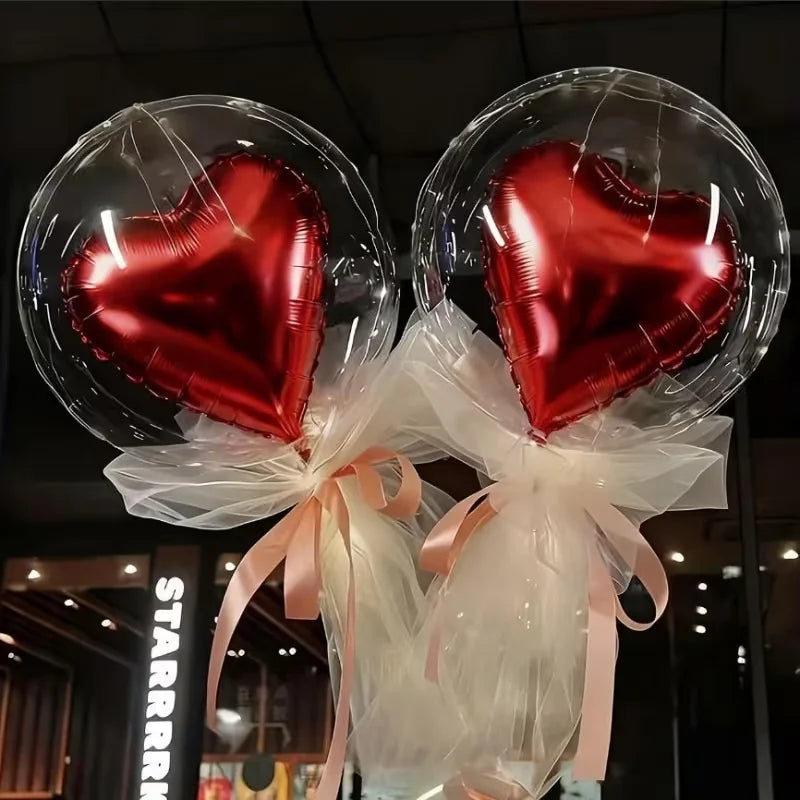 A set of heart-shaped foil and clear bubble balloons tied with sheer ribbons.