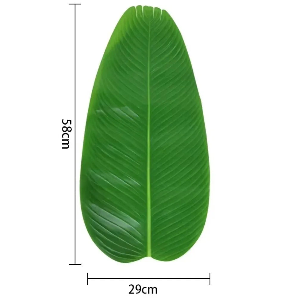 A single large, vibrant green tropical banana leaf used as a coaster or table protector.