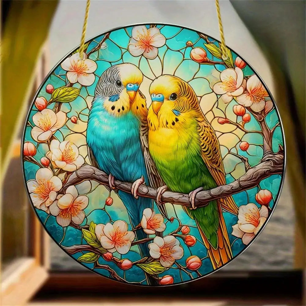 A colorful acrylic hummingbird suncatcher featuring two birds with yellow and blue plumage perched on branches surrounded by 
