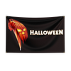 A black flag with the word HALLOWEEN in white text and a carved pumpkin design.