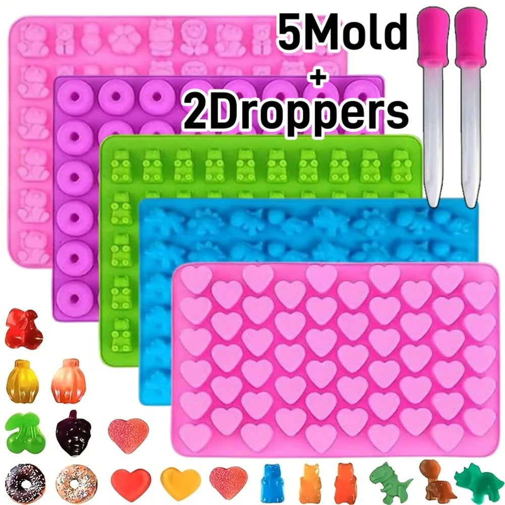 A pink silicone candy mold kit with 5 molds and 2 droppers, featuring various heart-shaped and animal-shaped silicone molds.