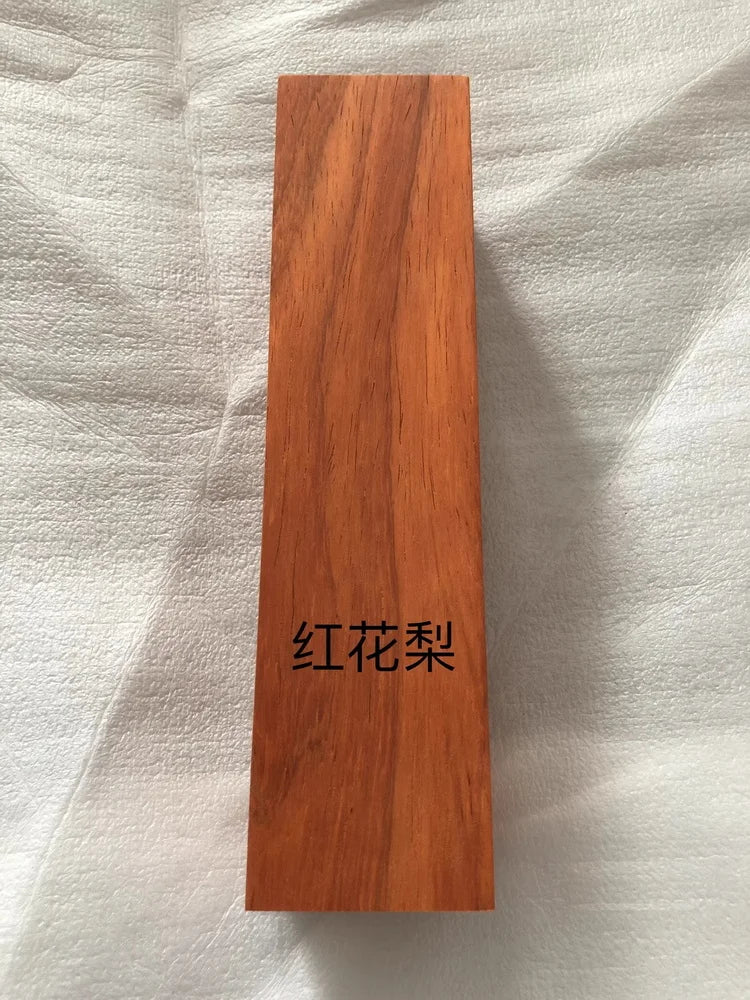 A rectangular block of reddish-brown wood, likely a blank for knife handles or DIY projects.