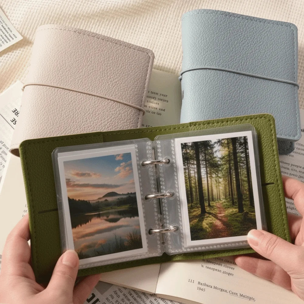 A green faux leather photo album is shown open, displaying several photos and next to a light blue leather cover.