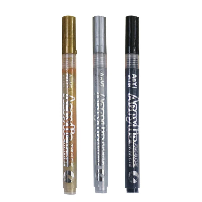 Three acrylic paint pens in gold and black packaging displayed vertically.