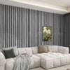 A modern living room featuring a gray vertical wood grain wallpaper and a white sectional sofa.