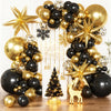A balloon garland arch featuring black and gold balloons, stars, and a Christmas tree decoration.