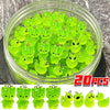 A clear jar filled with bright green glow-in-the-dark cartoon alien kitty duck resin charms for DIY jewelry.