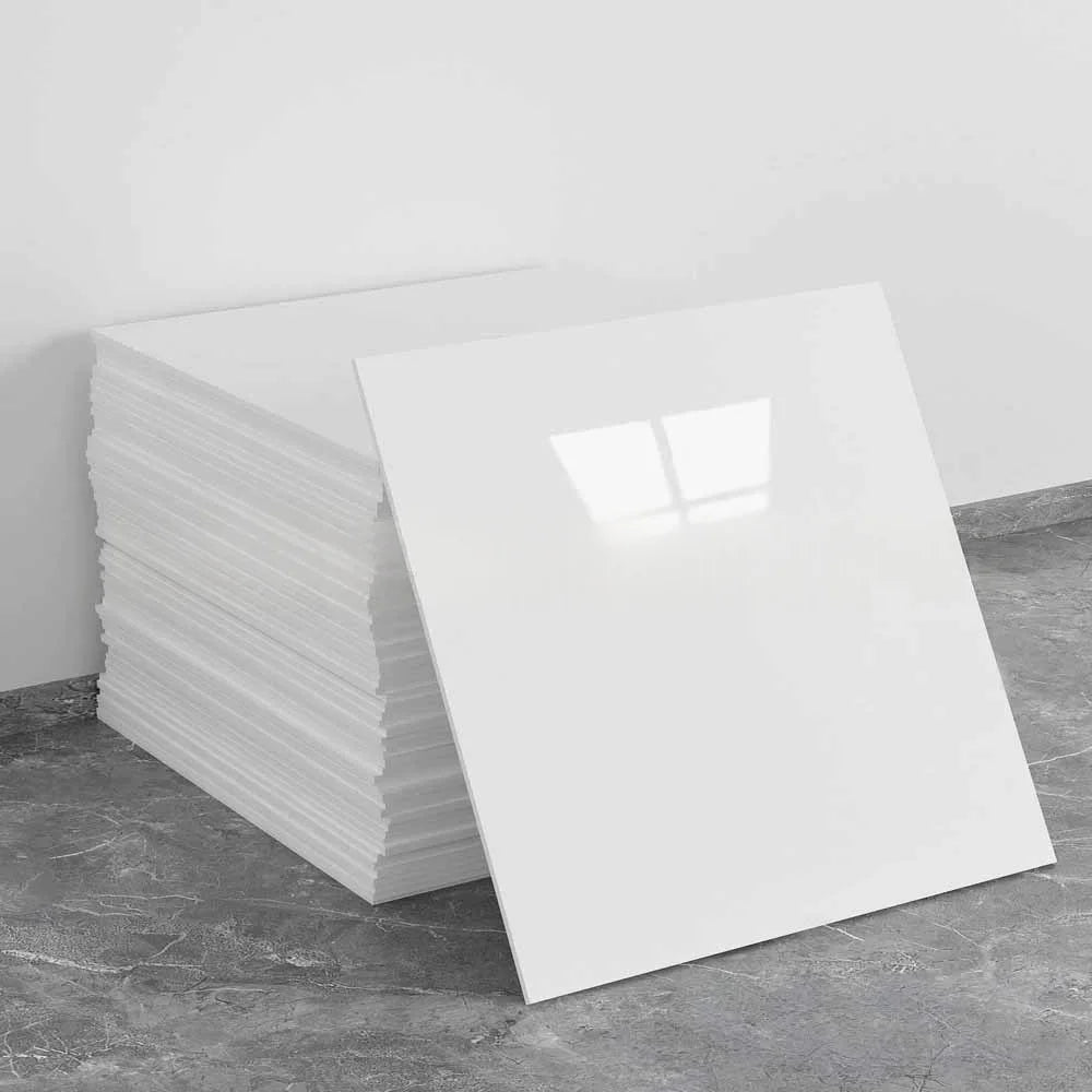 A stack of white self-adhesive marble tile stickers on a gray surface.