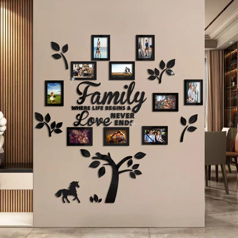 A wall decorated with various framed photos and silhouette tree designs, featuring the text Family Where Life Begins & Love N