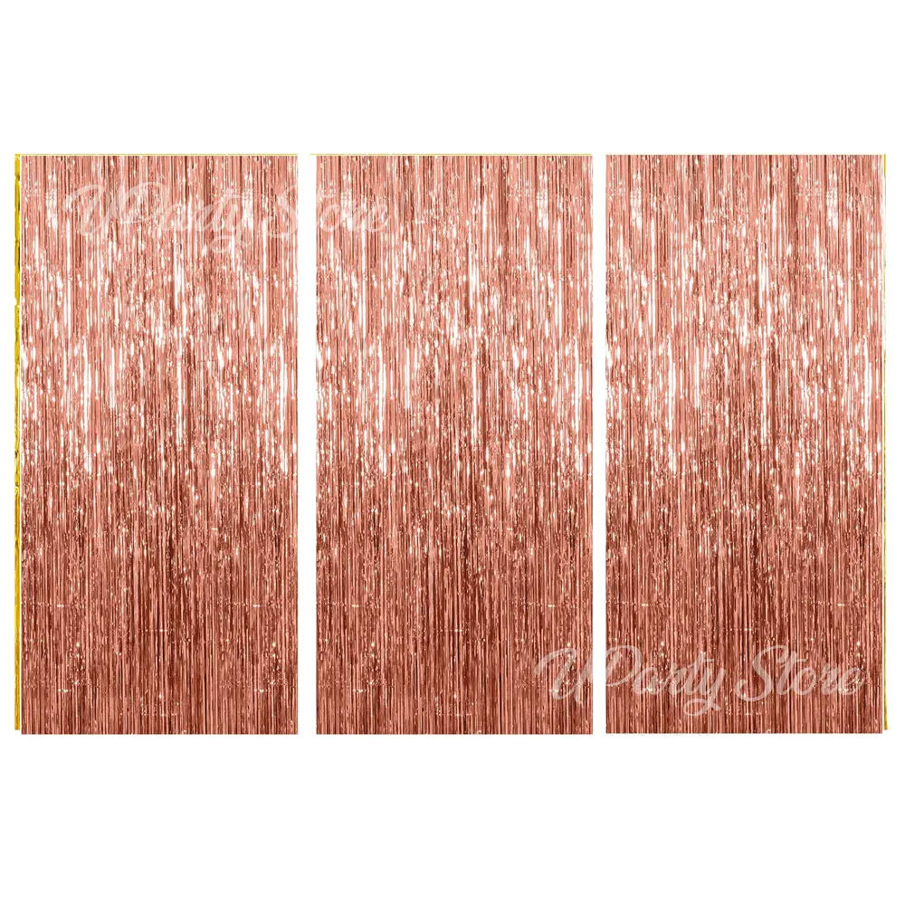 Three panels of metallic rose gold foil fringe curtains for party backdrop decor