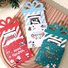 A set of three colorful cartoon Christmas thank you cards with festive designs displayed on a wooden surface.