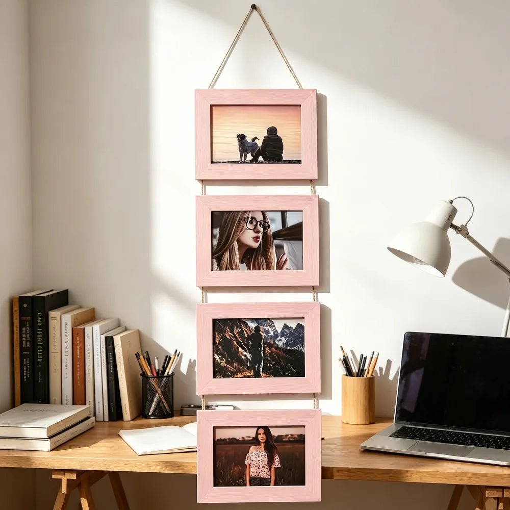 A set of four pink wooden photo frames displaying landscape and portrait photography on a light wood desk.