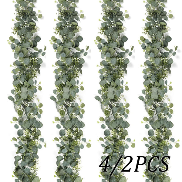 A vertical garland of artificial eucalyptus leaves in muted green tones for wedding and home decor