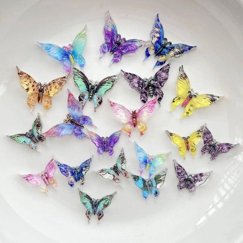 A collection of thirty colorful resin butterfly embellishments in various shades of blue, purple, and yellow scattered on a w