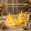 Decorative gift light featuring yellow LED star string candles glowing in glass holders on a table.