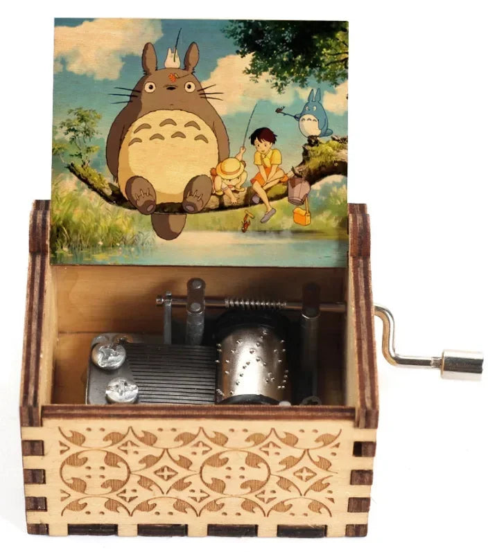 Hand-cranked wooden music box featuring a Totoro design on the lid.