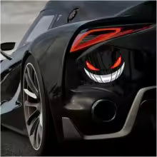 Close-up of a black sports car's headlight with an aggressive red eye design and a silver emblem decal.