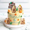 A yellow cake decorated with bear toppers and lettering for a birthday party