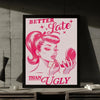 A framed print featuring a stylized illustration of a woman with pink hair, saying Better Late Than Ugly.