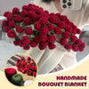 A handmade red rose bouquet blanket gift is displayed against a white sweater.