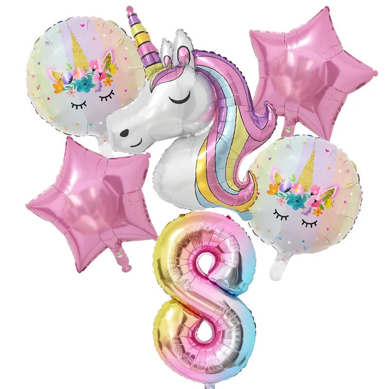 A collection of pink and iridescent foil balloons featuring unicorn designs, including a unicorn face balloon and star-shaped