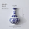 Blue and white ceramic wall vase with a narrow neck and decorative patterns