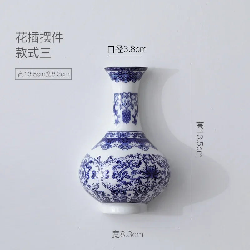 Blue and white ceramic wall vase with a narrow neck and decorative patterns