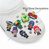 A white acrylic cake topper featuring various character designs and decorations for a birthday celebration.