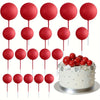 A set of twenty red ball cake toppers on sticks arranged in a grid.