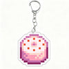 A clear acrylic keychain charm featuring a pixelated design in shades of pink and purple.