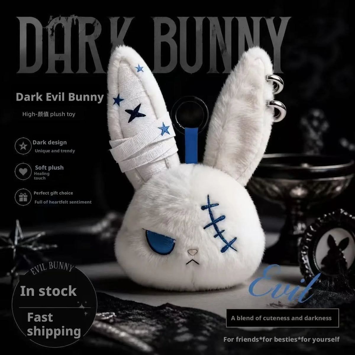 A white plush bunny toy with blue accents and a bandage design displayed on a dark background.