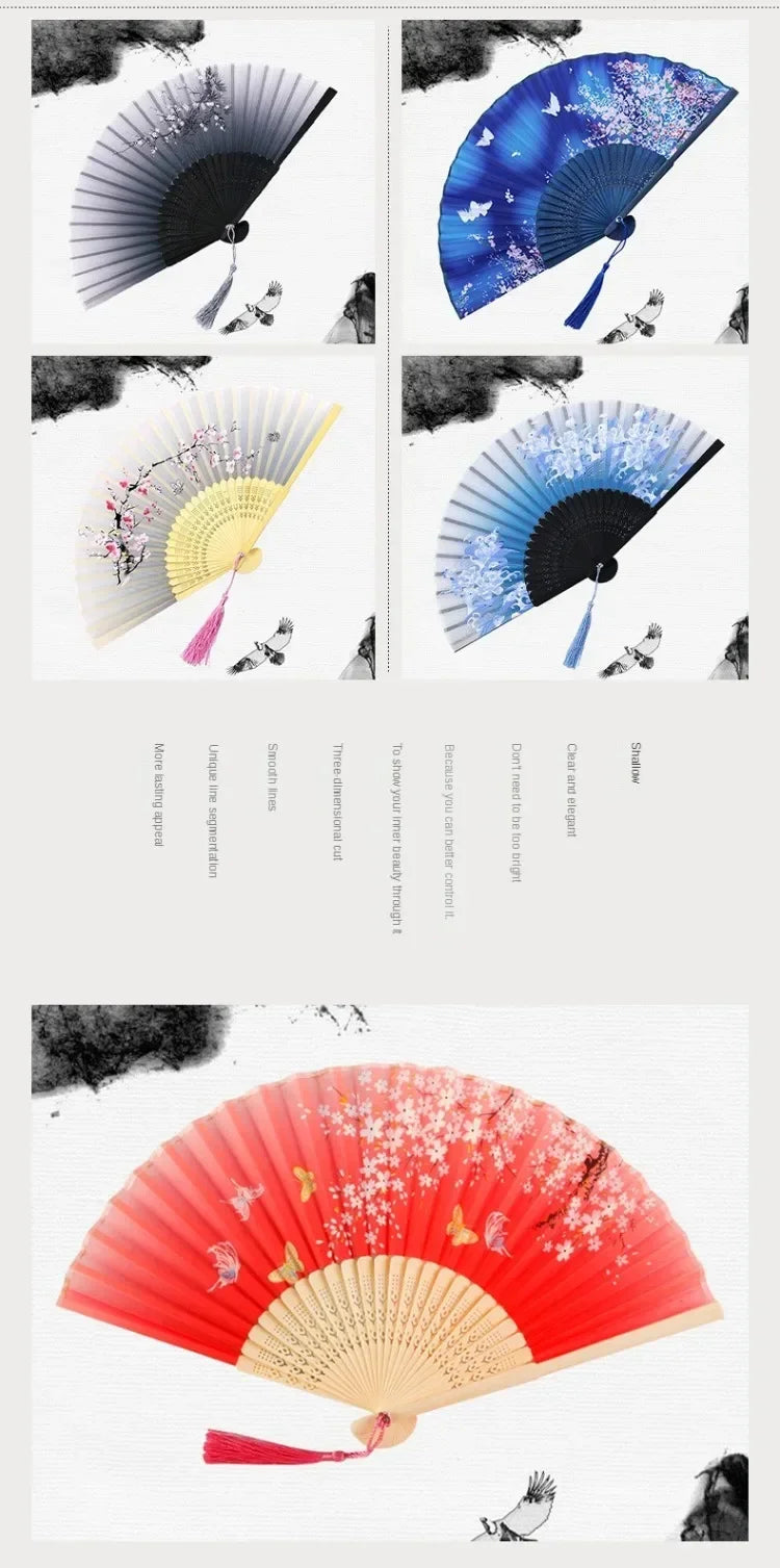 A close-up of a vintage bamboo folding hand fan with red and pink floral accents.